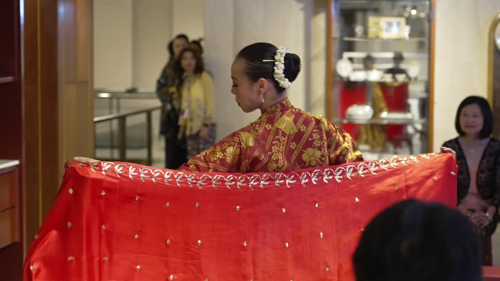 A model turns in a flowing shawl at the Kenangan Kebaya showcase